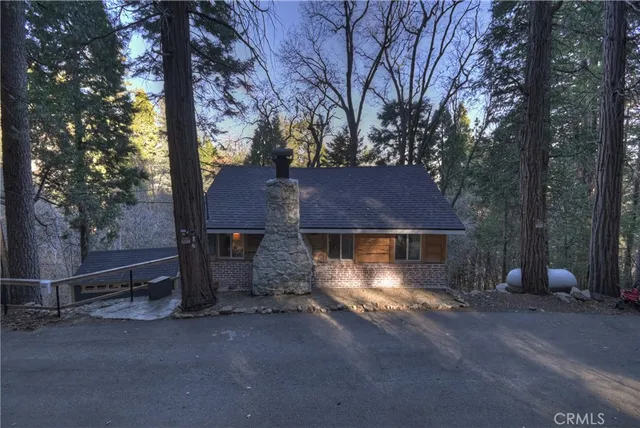 a view of a house with a yard and a tree