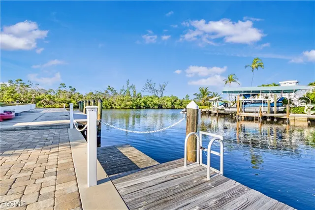 a view of a lake with boats and trees in the background