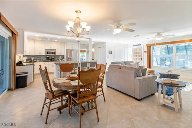 a view of a dining room with furniture and a chandelier