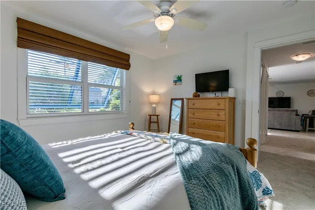 a bedroom with a bed and a television