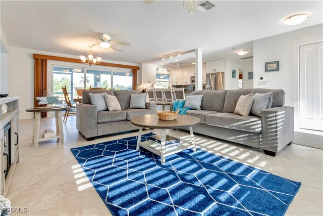 a living room with furniture a lamp and a table