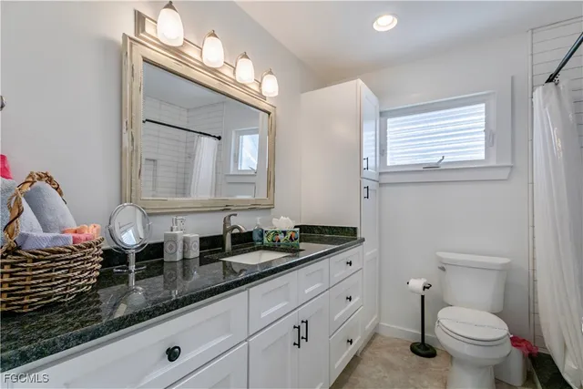 a bathroom with double sink and a mirror