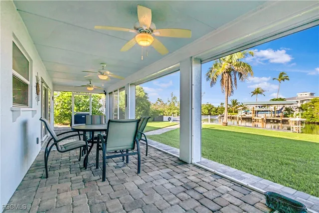 a view of a porch with chairs and backyard