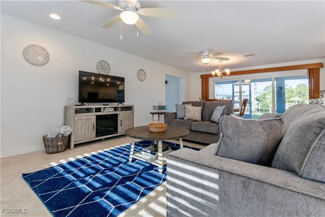 a living room with furniture a dining table and a fireplace