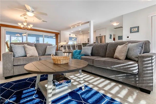 a living room with furniture a dining table and a fireplace