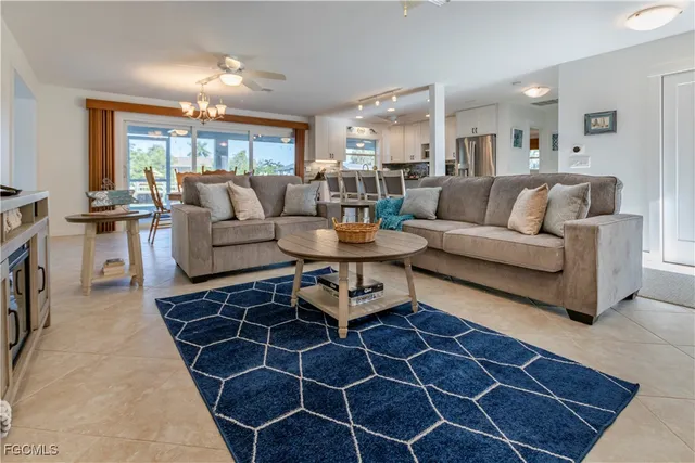 a living room with furniture a dining table and a fireplace