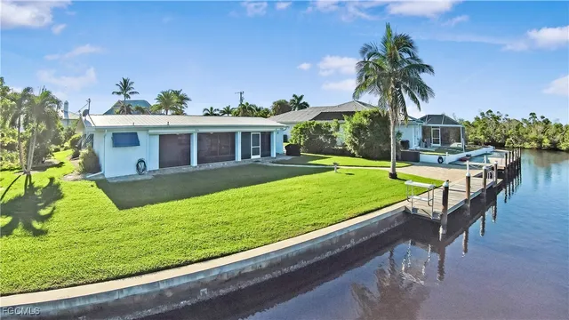 a view of a house with a yard patio and swimming pool