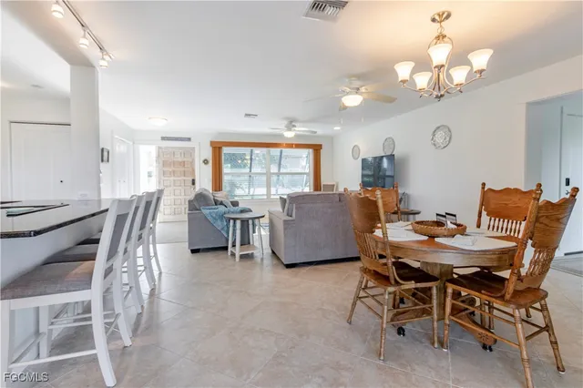 a view of a dining room with furniture and a chandelier