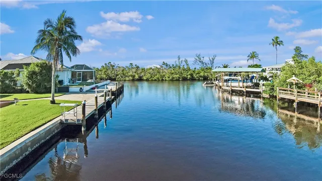 a view of a lake with a table and chairs