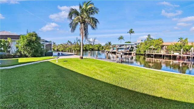 a view of a swimming pool with a garden and lake view