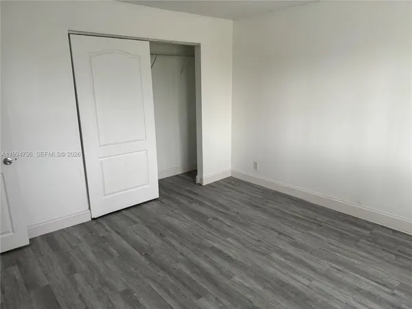 an empty room with wooden floor