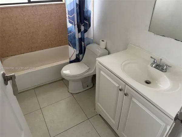 a bathroom with a sink a toilet and bathtub