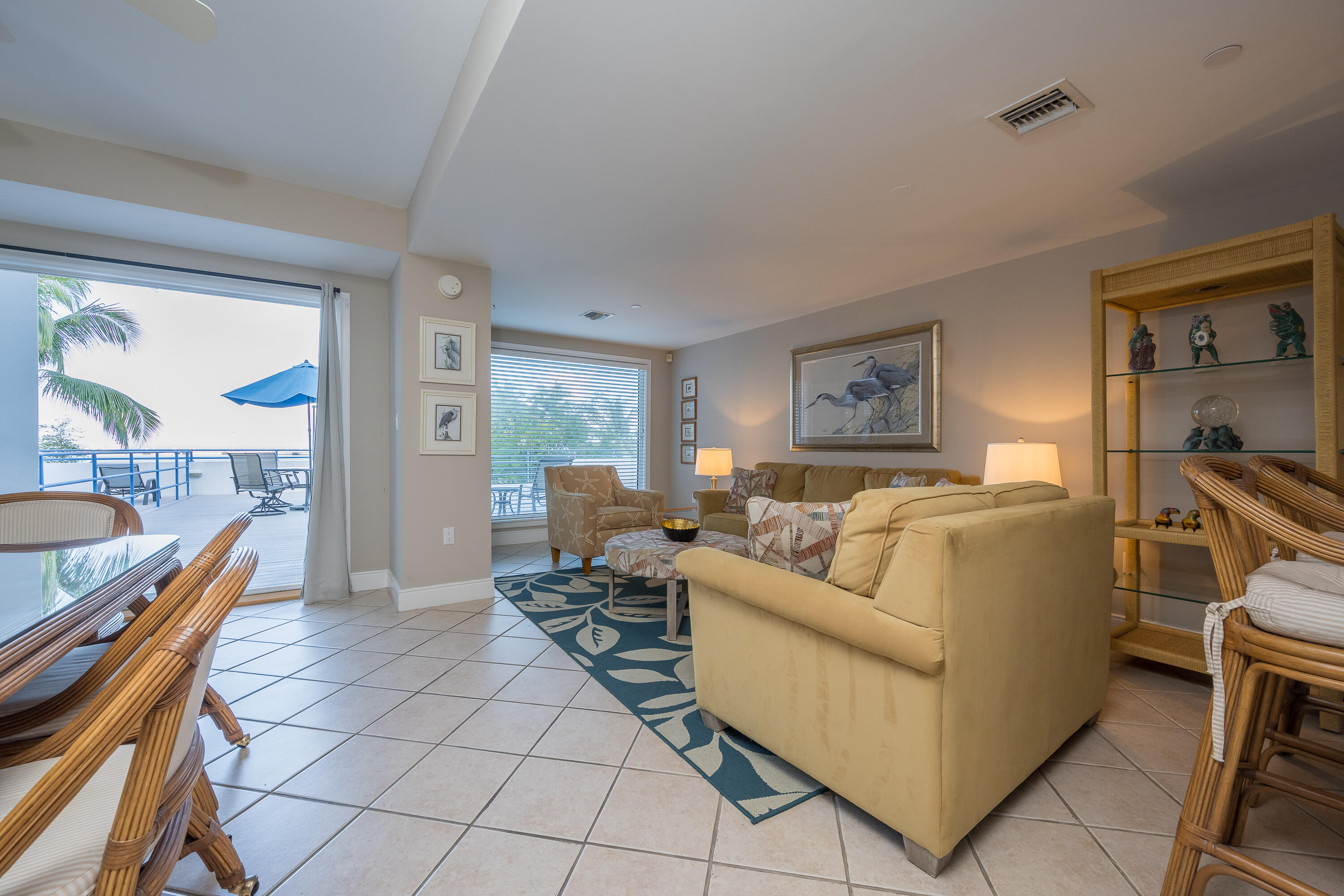 105 Front Street, Unit 119 Key West, FL 33040 - Photo 2 of 6 a living room with furniture and a table