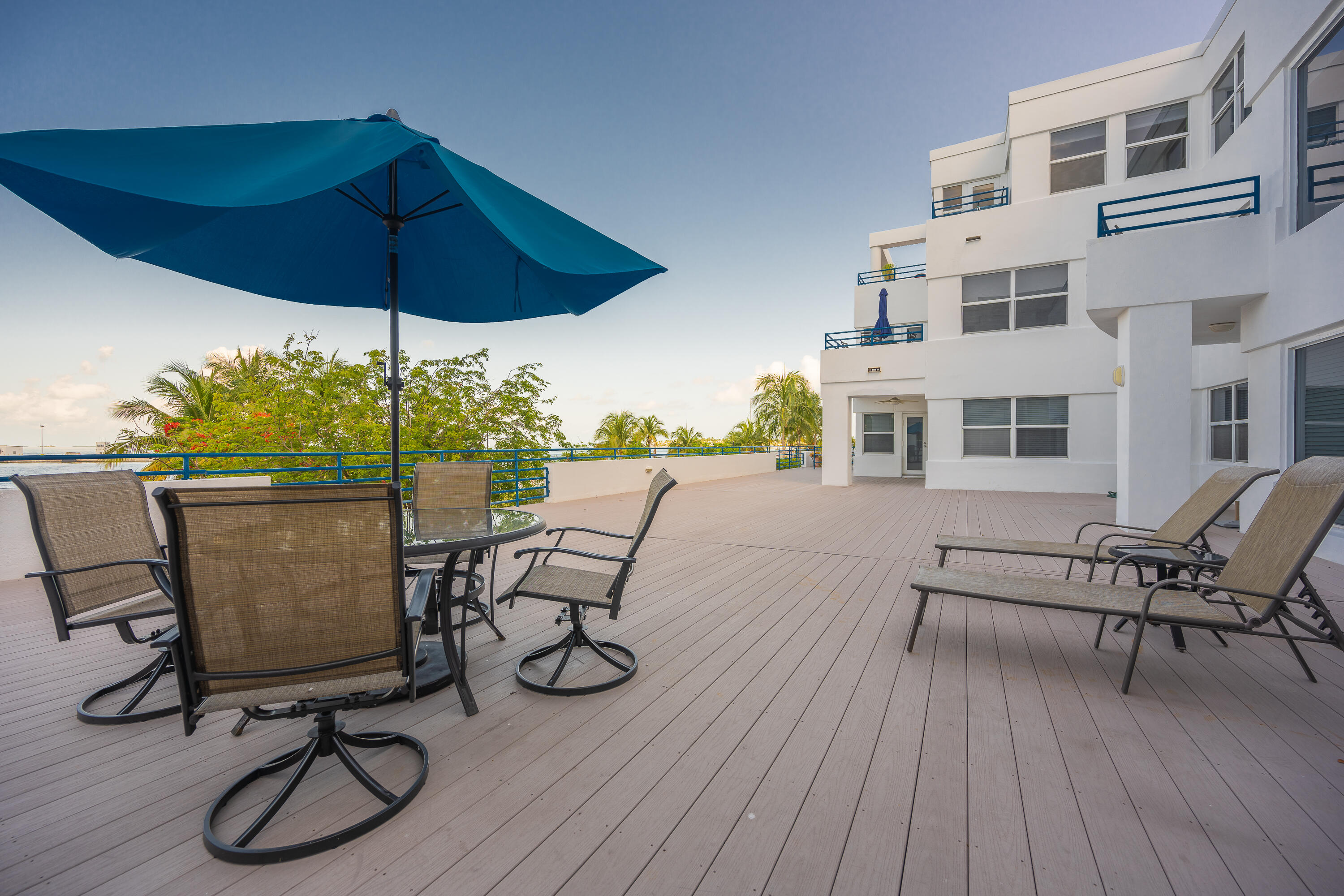 105 Front Street, Unit 119 Key West, FL 33040 - Photo 3 of 6 a view of a roof deck with table and chairs under an umbrella