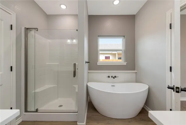 a bathroom with a bathtub and shower
