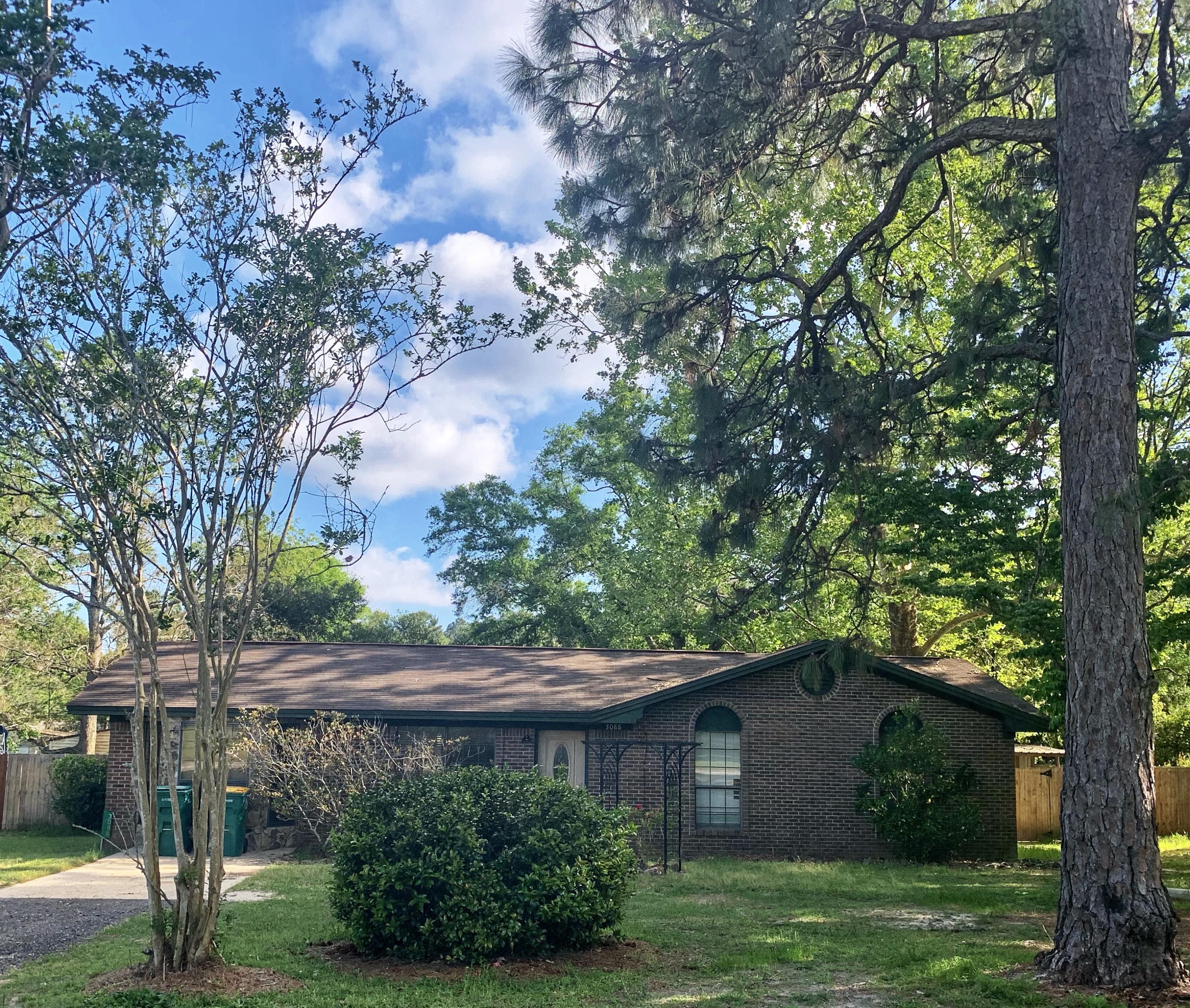 3088 Butler Road North Crestview, FL 32539 - Photo 1 of 6 a backyard of a house with lots of green space