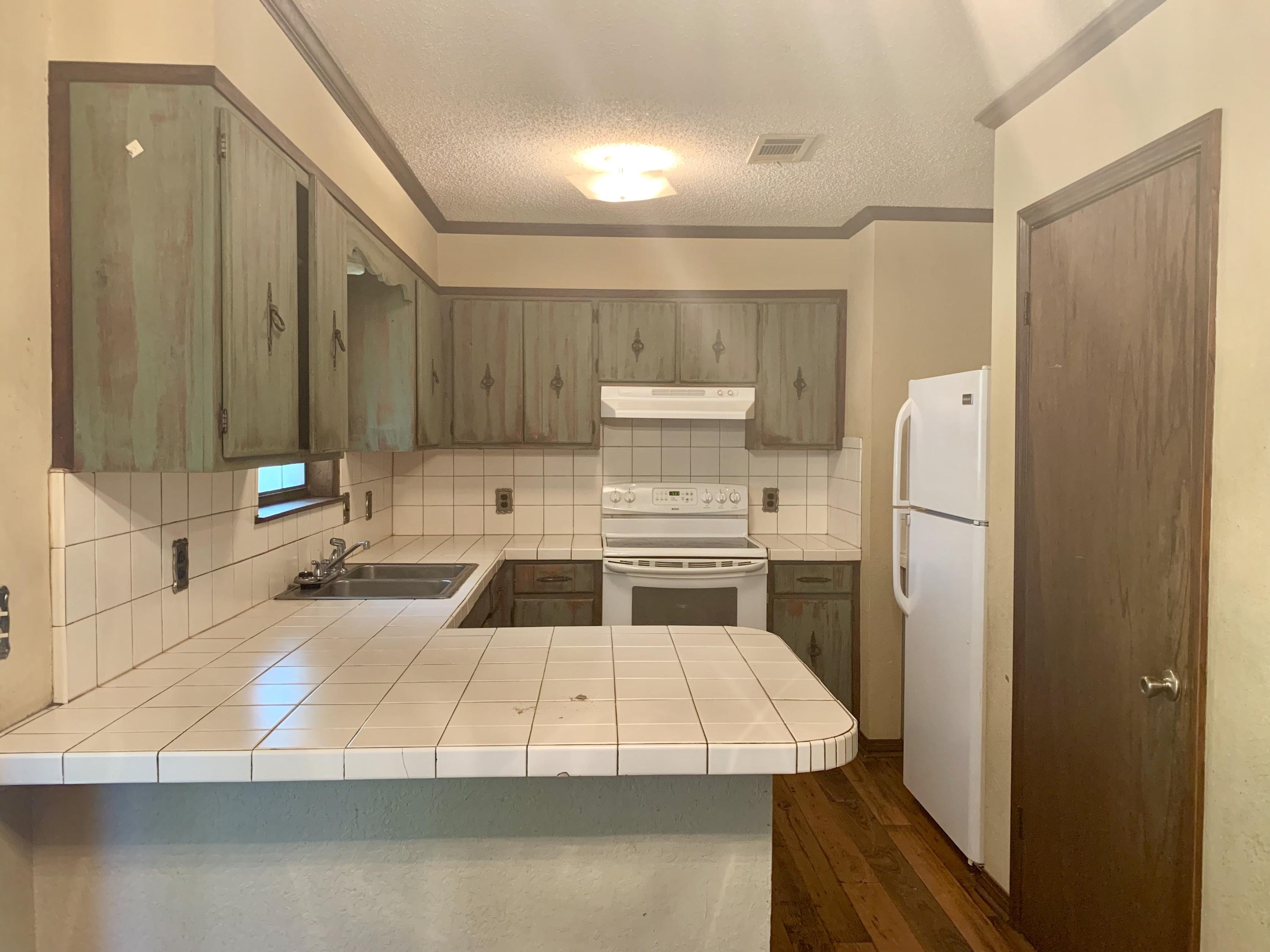 3088 Butler Road North Crestview, FL 32539 - Photo 6 of 6 a kitchen with a refrigerator sink and stove