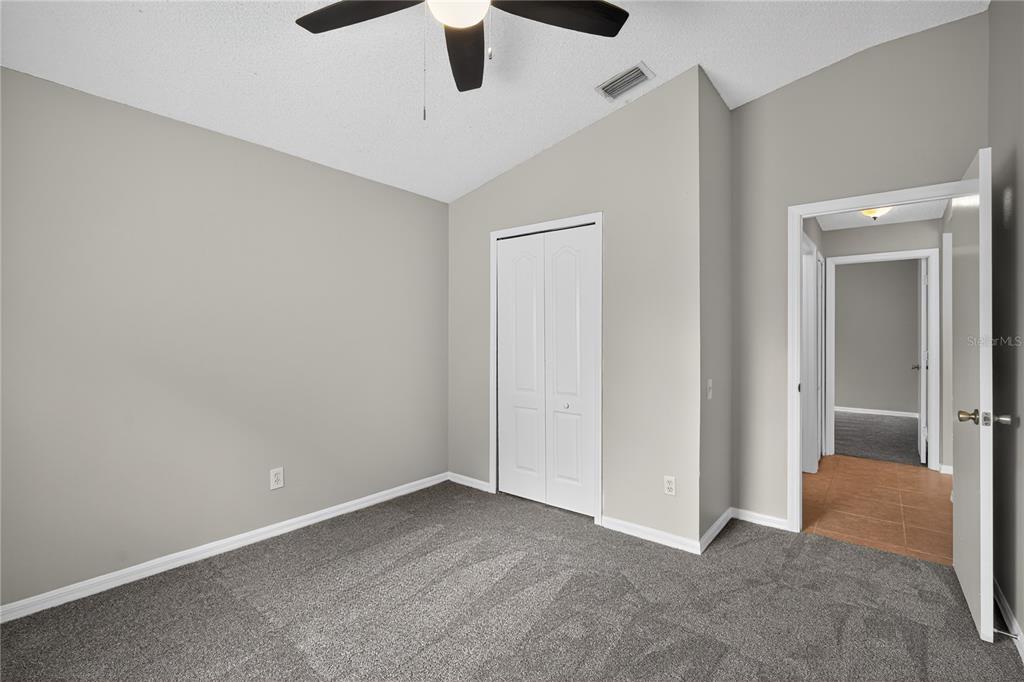 12630 Early Run Lane Riverview, FL 33578 - Photo 13 of 32 an empty room with ceiling fan and window