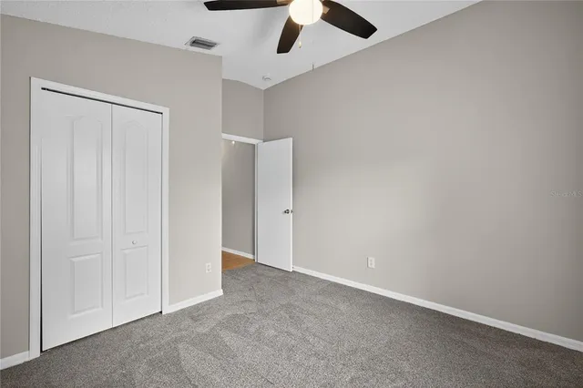 an empty room with a empty space and a ceiling fan