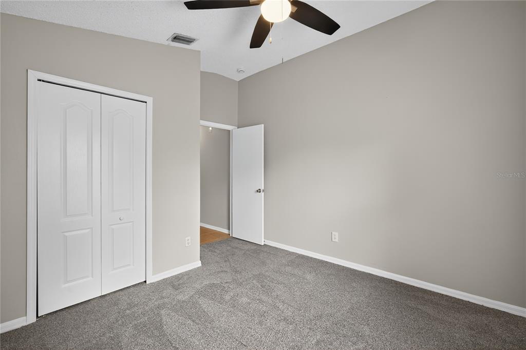 12630 Early Run Lane Riverview, FL 33578 - Photo 15 of 32 an empty room with a empty space and a ceiling fan