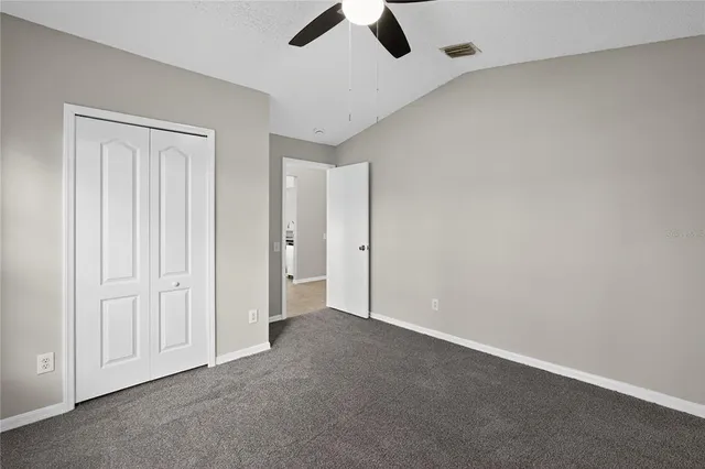 an empty room with view of ceiling fan
