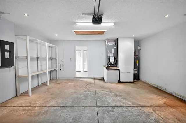 a view of a kitchen with refrigerator and window