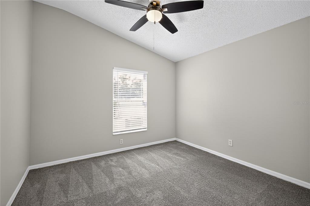 12630 Early Run Lane Riverview, FL 33578 - Photo 5 of 32 an empty room with a window and a fan