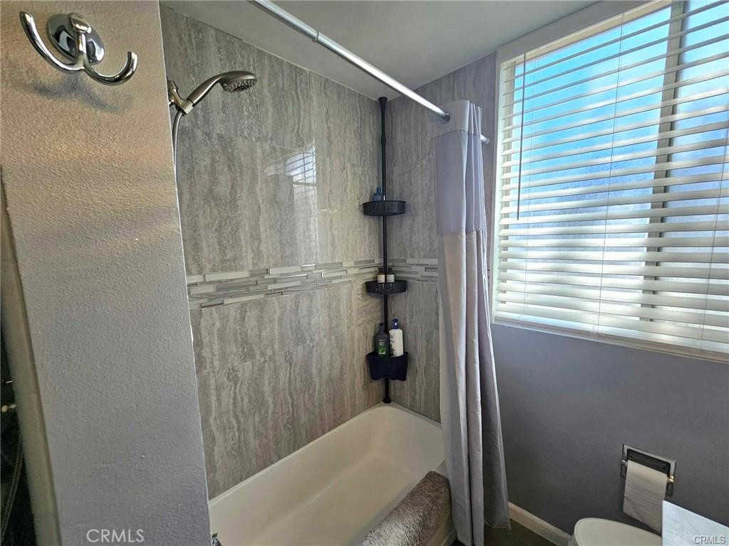 6979 Palm Court, Unit 126H Riverside, CA 92506 - Photo 11 of 25 a bathroom with a bathtub and shower
