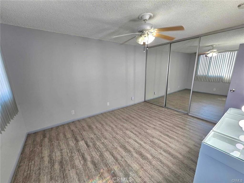 6979 Palm Court, Unit 126H Riverside, CA 92506 - Photo 16 of 25 wooden floor in an empty room with a window