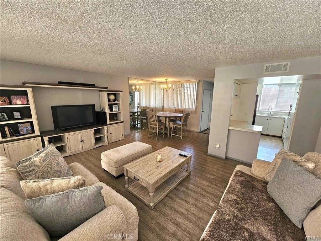 6979 Palm Court, Unit 126H Riverside, CA 92506 - Photo 2 of 25 a living room with furniture and a flat screen tv