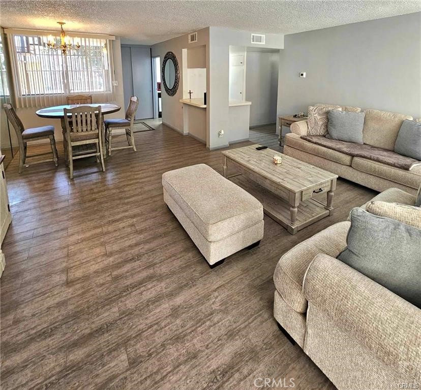 6979 Palm Court, Unit 126H Riverside, CA 92506 - Photo 6 of 25 a living room with furniture and wooden floor