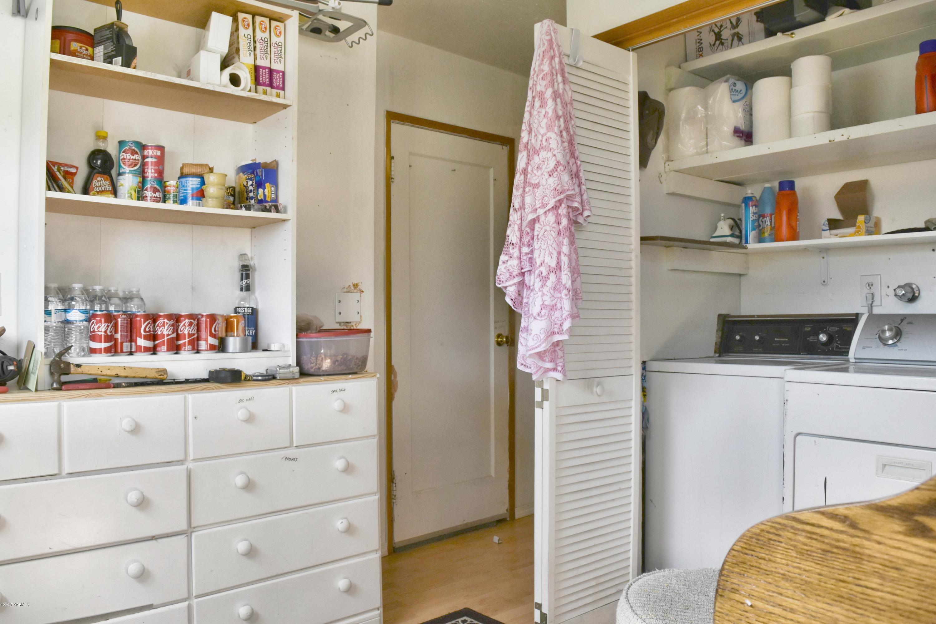941 Franklin Road Tieton, WA 98947 - Photo 11 of 15 a bedroom with a bed and a refrigerator