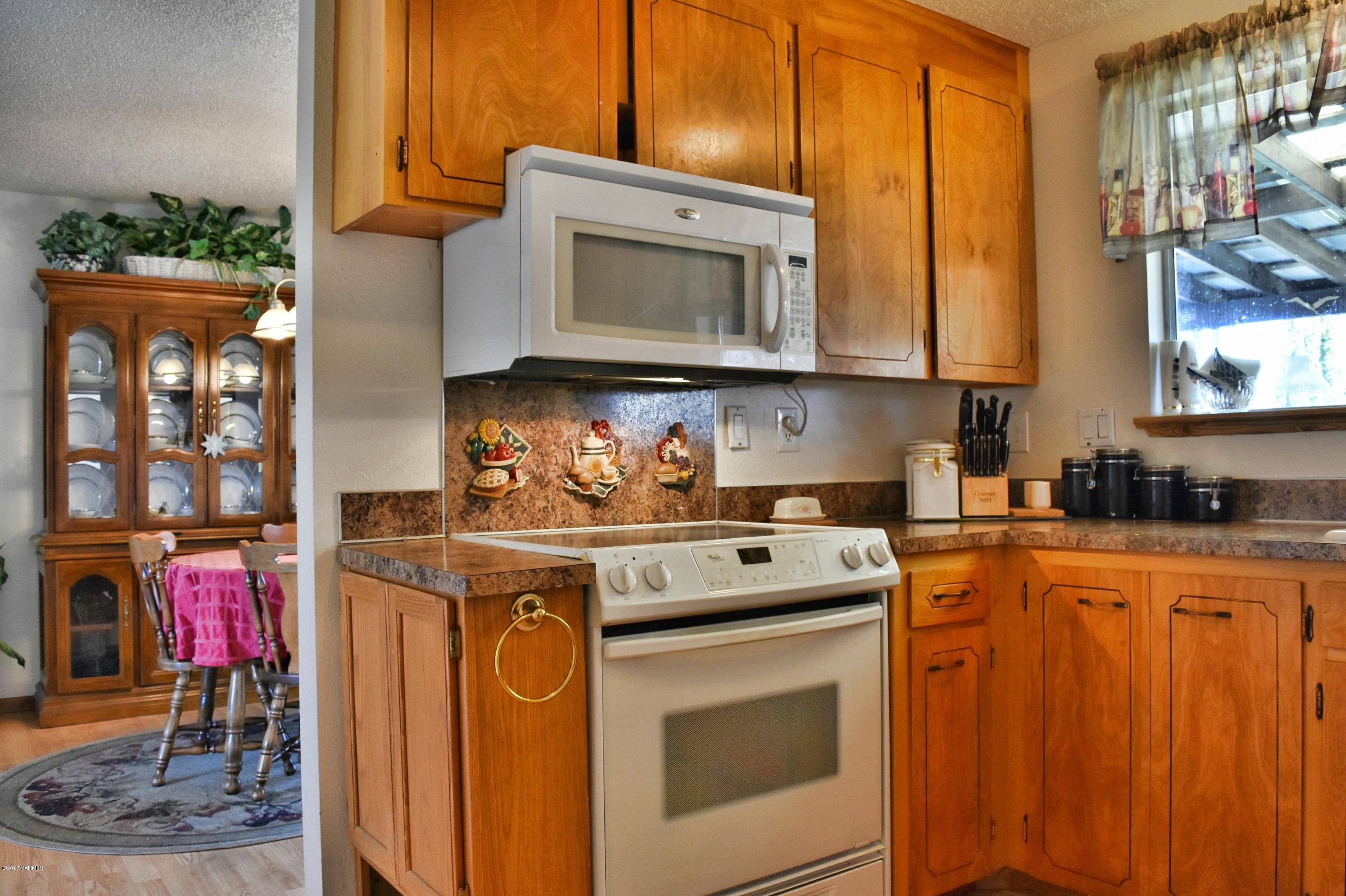 941 Franklin Road Tieton, WA 98947 - Photo 3 of 15 a kitchen with stainless steel appliances granite countertop a stove a sink and a microwave