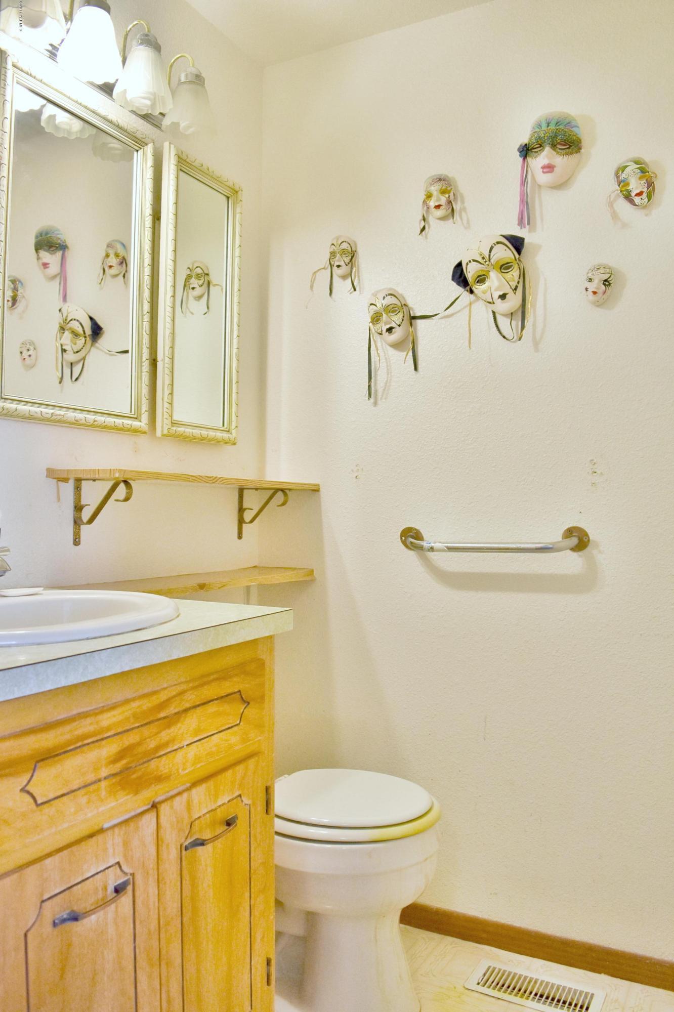 941 Franklin Road Tieton, WA 98947 - Photo 9 of 15 a bathroom with a sink a toilet and vanity