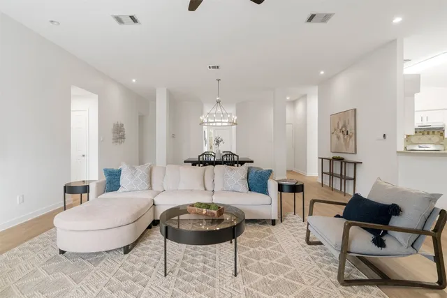 a living room with furniture and a chandelier