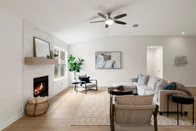 a living room with furniture and a fireplace
