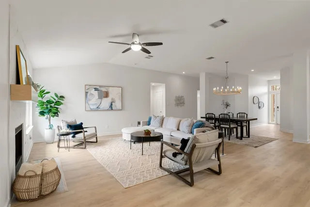 a living room with furniture and a chandelier