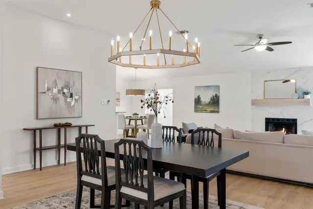 a view of a dining room with furniture and chandelier