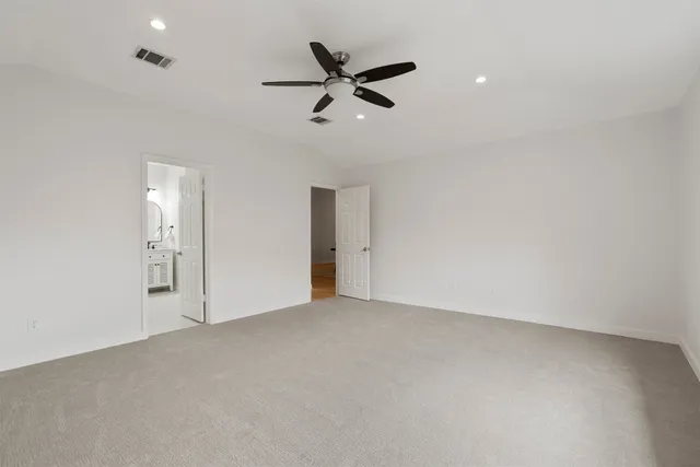 an empty room with closet and windows