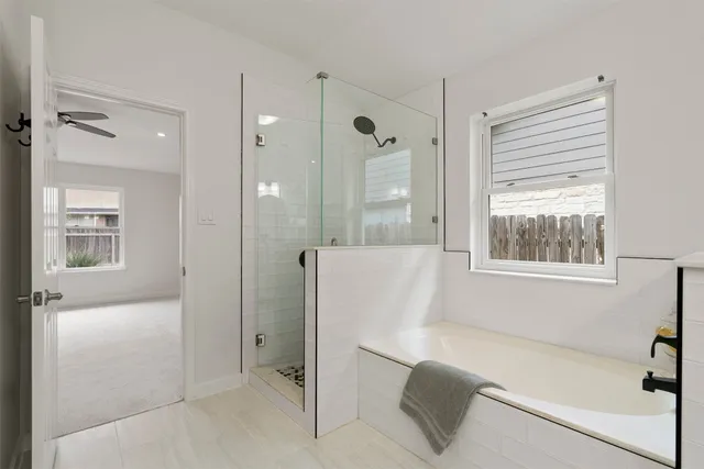 a bathroom with a bathtub and a shower
