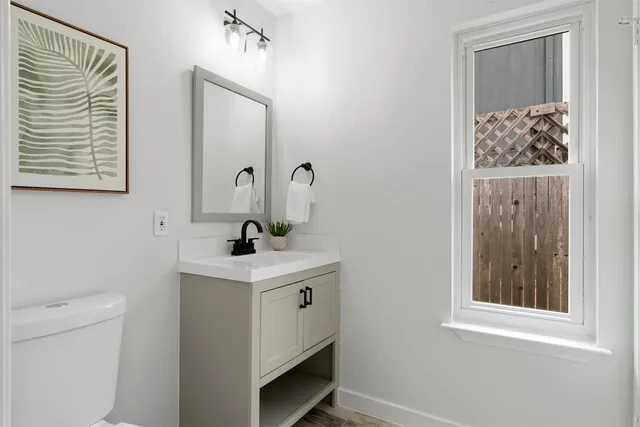 a bathroom with a toilet a sink and a mirror