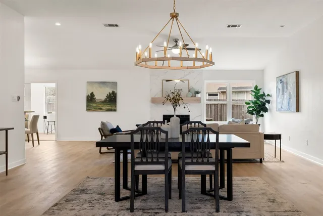 a view of a dining room with furniture and chandelier