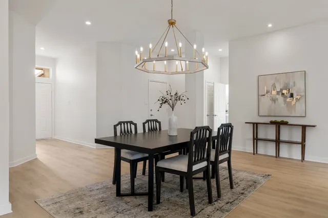 a view of a dining room with furniture and chandelier