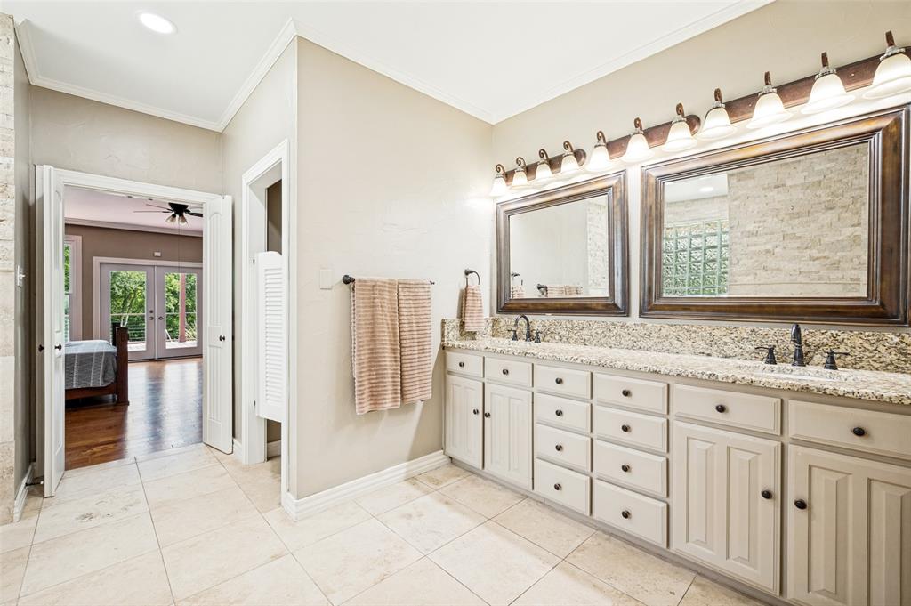 9 Country Ridge Road Melissa, TX 75454 - Photo 18 of 37 The Primary bath has 2 sinks, soft travertine flooring and granite counters.