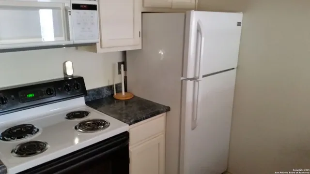 a kitchen with a stove and a refrigerator