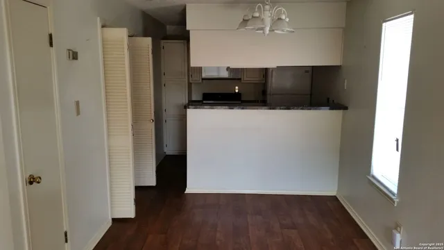 a view of a kitchen from the hallway