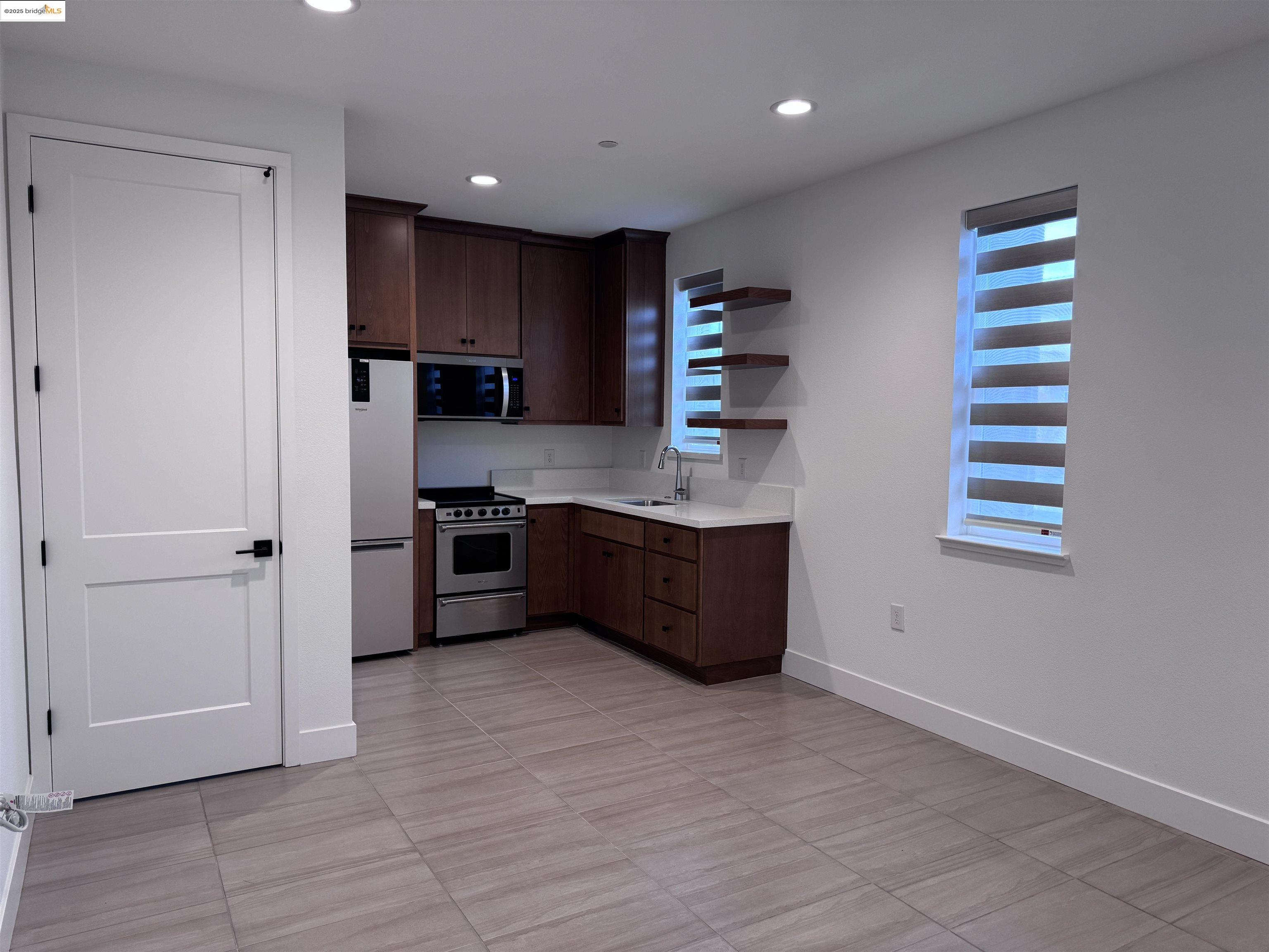 470 Trellis Way, Unit A Brentwood, CA 94513 - Photo 3 of 14 a kitchen with stainless steel appliances a sink and a refrigerator