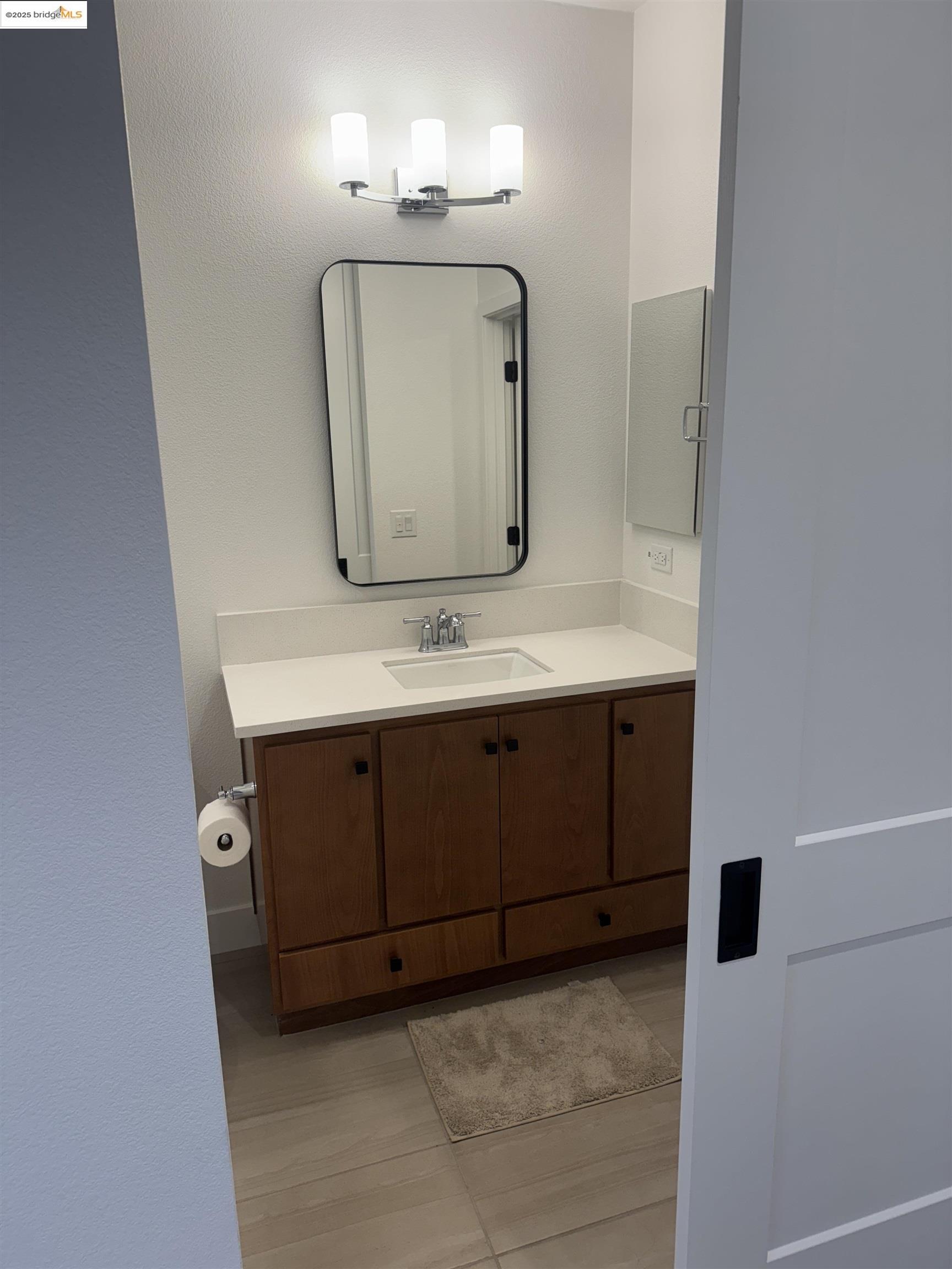 470 Trellis Way, Unit A Brentwood, CA 94513 - Photo 10 of 14 a bathroom with a sink a mirror and vanity