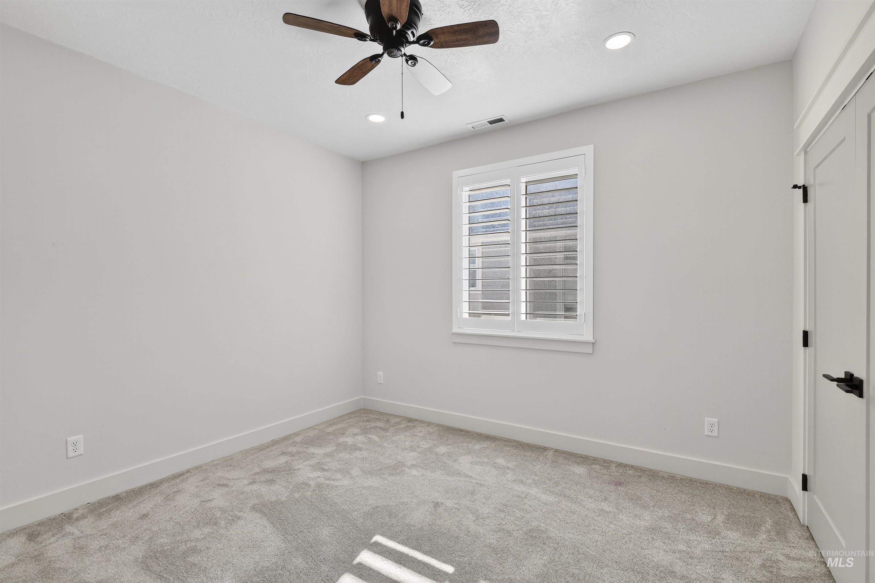 6839 North Willowside Avenue Meridian, ID 83646 - Photo 18 of 38 Unfurnished room featuring light carpet, recessed lighting, and a ceiling fan