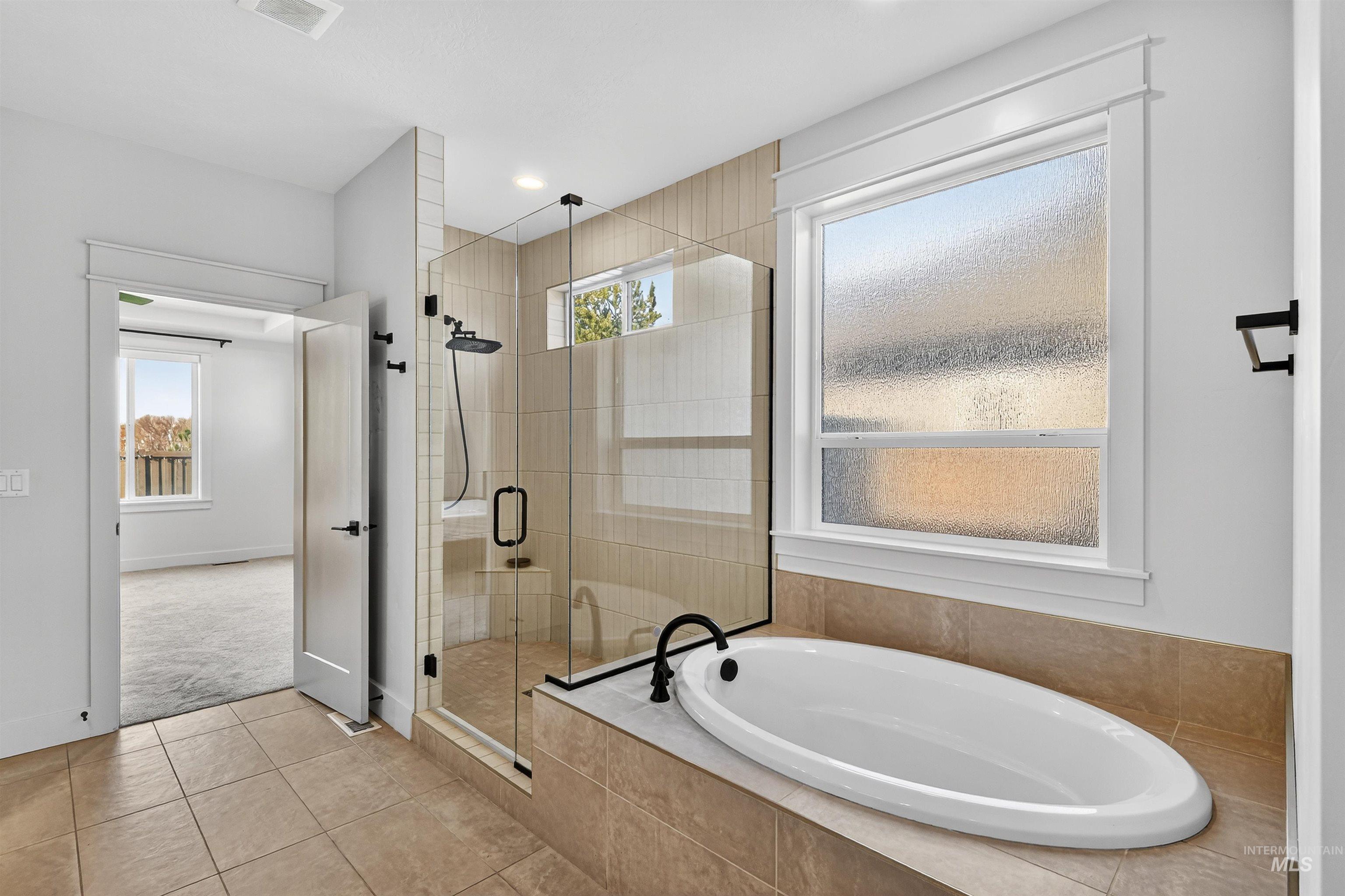 6839 North Willowside Avenue Meridian, ID 83646 - Photo 21 of 38 Full bath with a bath, tile patterned flooring, a stall shower, and recessed lighting